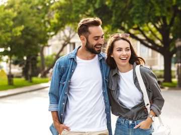 Young couple walking outdoors reconnecting after resolving resentment in their relationship in Ottawa