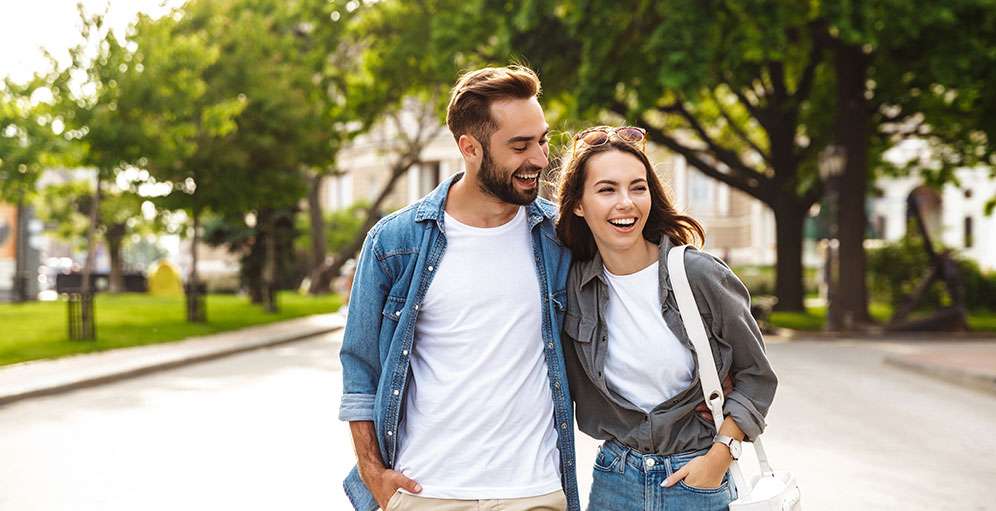 Young couple walking outdoors reconnecting after resolving resentment in their relationship in Ottawa