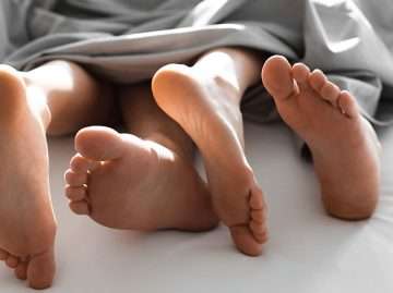 Couple embracing intimately in bed