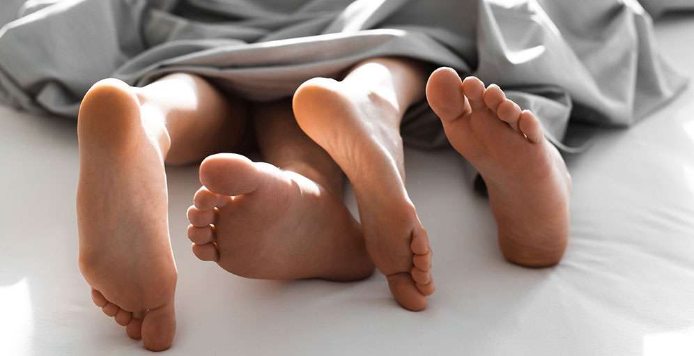 Couple embracing intimately in bed